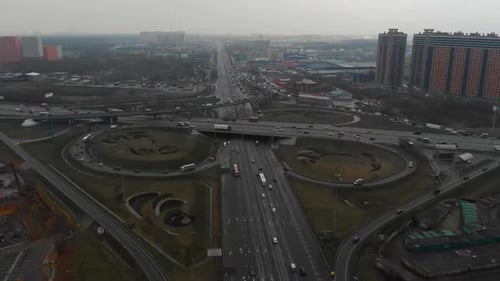 Ansicht von oben auf eine Hauptstraße in der Stadt. Ansicht von oben auf die Straßenkreuzung. Die Kamera fliegt über die