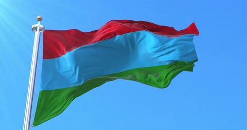Flag Waving with Red Blue Green Stripes Against a Clear Sky