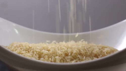 Rice Being Poured into a White Bowl