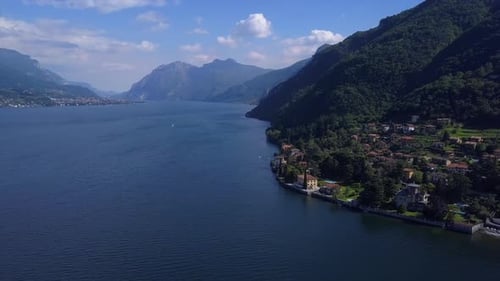 Aerial Flying Over Mountain Lake Como in Italy, Lakeside Village and Beautiful Villas, Sunny Weather