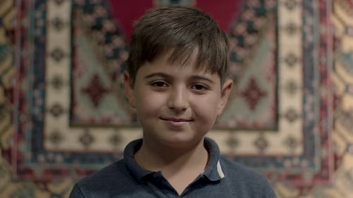 Smiling Boy Portrait Against Colorful Textile Background