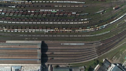 Train Station with Freight Trains and Containers in Aerial View. Aerial Shooting Top Down Footage