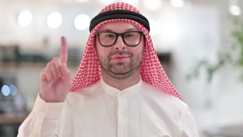 Adult Man with Keffiyeh Raising Index Finger