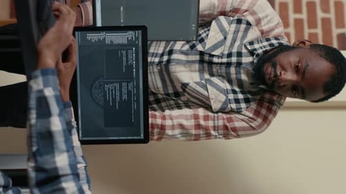 Software Engineers Collaborating On Code At Urban Office