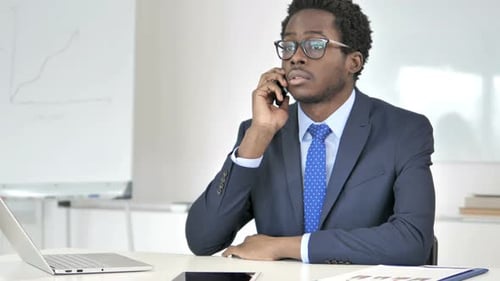 Professional Young Adult in Suit Talking on Phone