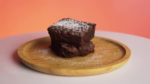 Stacked Brownie on Wooden Plate with Powdered Sugar