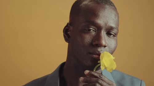 Man Smelling Yellow Flower Close Up Portrait