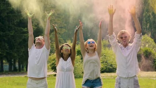 Four Young People Spraying the Colorful Powder in Extra Slow-Motion Holi Fest