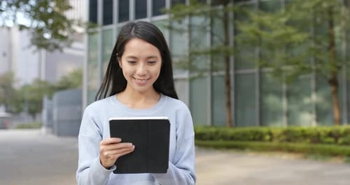 Woman Using Tablet in Urban Setting