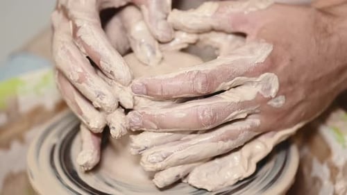 Couple Hands Making a Pot on a Pottery Workshop