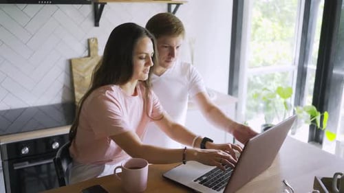 Young Adults Working on Laptop at Home