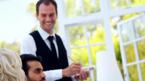 Smiling waiter interacting with customers