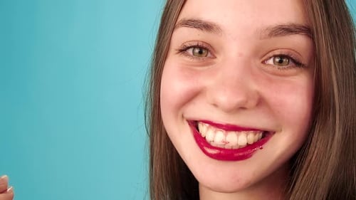 Girl Applies Red Lip Gloss Close Up