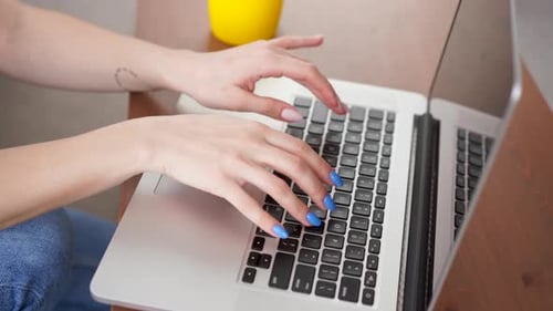 Woman Typing on Laptop Keyboard Close Up