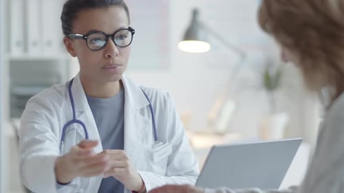 Doctor Explains Prescription to Patient in Office