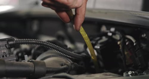 Mechanic Draining Old Brake Fluid From A System During The Service. Close Up