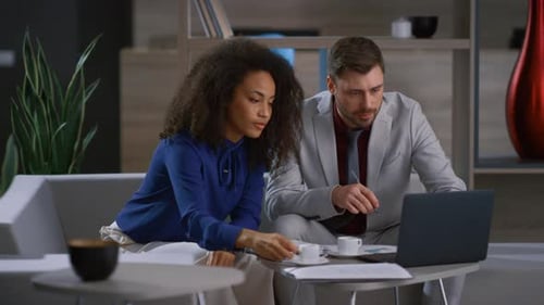 Multiethnic Corporate Couple Working Laptop Computer in Cafe Workplace Office