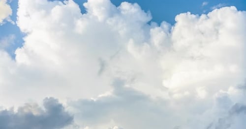 Fluffy Clouds Drifting Across a Blue Sky
