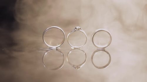 Three Wedding Rings Reflect in Smokey Haze