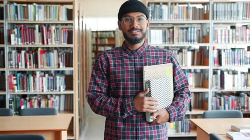 Slow Motion of Cheerful African American Adult Student Holding Books in Library