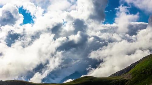 Dynamic Clouds Flowing Over Rolling Hills Landscape