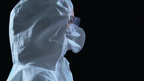 Researcher in Protective Uniform Turning to Camera, Radioactive Pollution Hazard