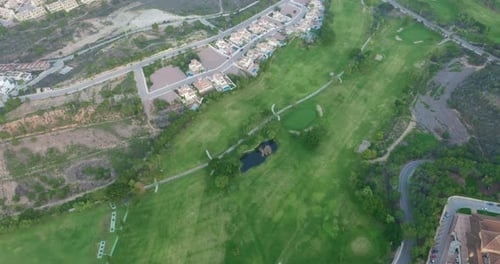Aerial View. Golf Course with Green Field in the Valley. Green Turf Scenery.