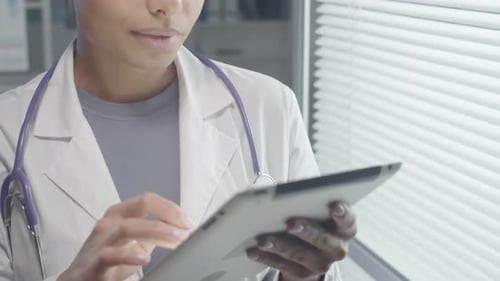 Female Doctor Using Tablet in Office Environment