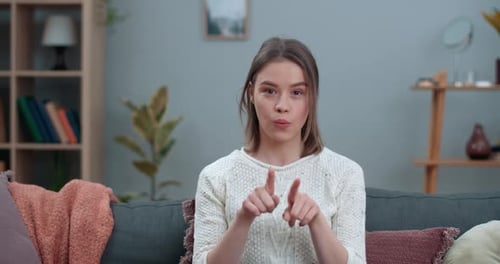 Young Adult Woman Signing on Couch Indoors