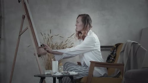 Woman Artist Painting on Canvas in Studio