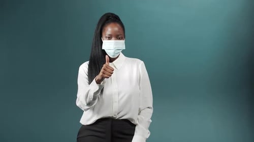 Black Woman with Long Black Hair Wear Face Mask on Isolated Color Background New Normal Lifestyle