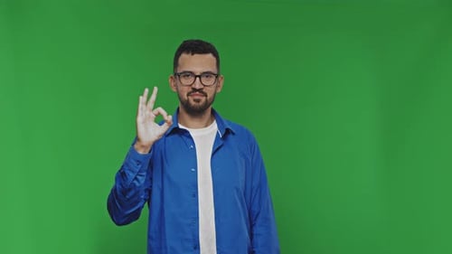 Man Makes OK Gesture on Green Screen