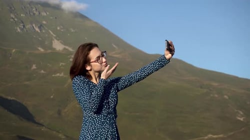 Woman Taking Selfie in Front of Mountains