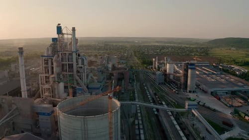 Cement Plant with High Factory Structure at Industrial Production Area at Sunset