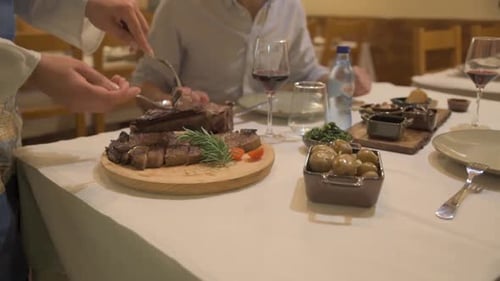 Waiter Serves Customers In Restaurant