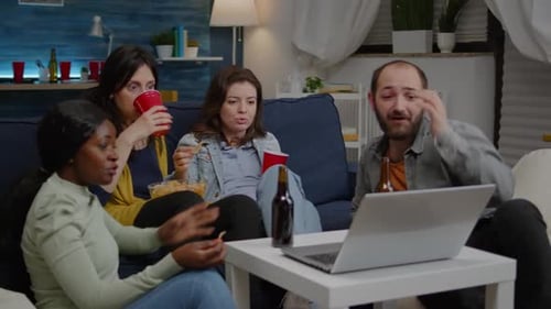 Friends Watching a Laptop at Home