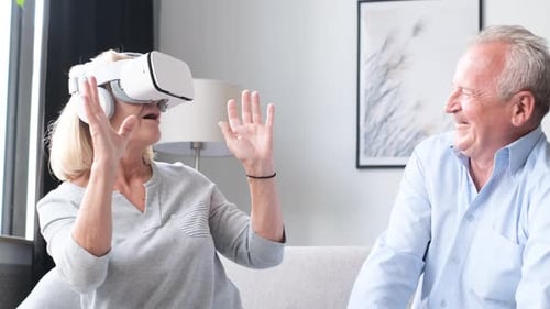 Senior Woman Using VR Headset with Laughing Man