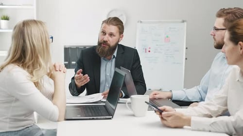 Team Discussing Business Strategy in Modern Office