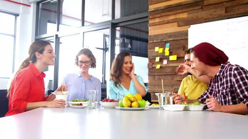 Coworkers Enjoying Lunch Together at Modern Workplace
