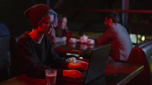 Female Programmer Sitting in Bar