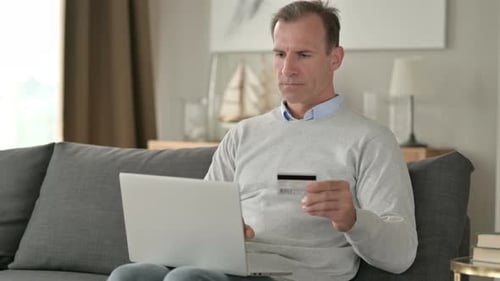 Attractive Businessman Successful at Online Payment on Smartphone