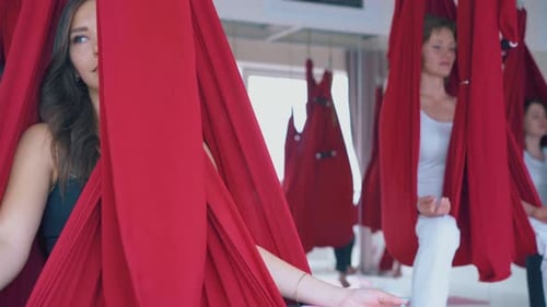 Young Women Doing Aerial Yoga in Studio