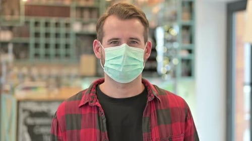 Man with Mask Stares at Camera