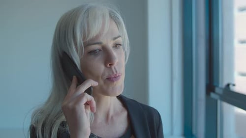 Woman Talking on Phone in Office Environment