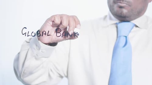 Man Writing Global Banking with a Marker