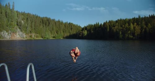 Man Run on Dock To Jump in Cold Mountain Lake