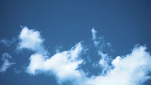Clouds and Airplane in a Blue Sky