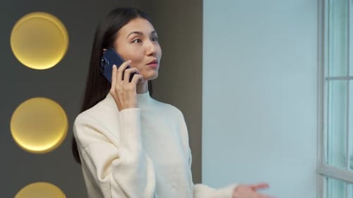 Woman Chatting on Smartphone Indoors