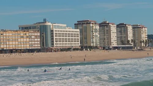 People swimming near the Seixal beach, Lisbon, on a sunny winter day.