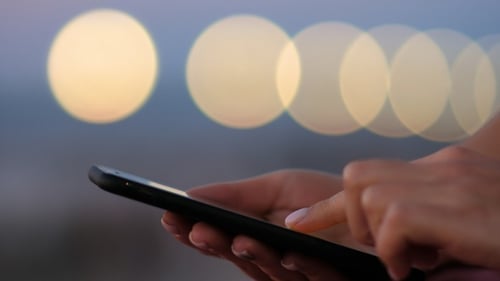 Woman using smartphone in the city - scrolling and touching.
